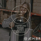 AEMBR founder in warehouse holding metal containers, promoting Made in the USA and Women Business Enterprise.
