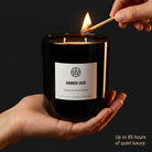 Amber Oud candle from AEMBR, featuring a warm, scented candle with amber and oud notes in a sleek glass holder.