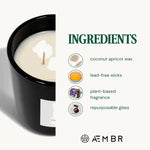 AEMBR candle with coconut apricot wax, lead-free wicks, plant-based fragrance in black glass.