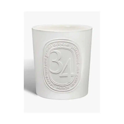 White non-toxic decorative candle in ceramic jar with embossed number 34, minimalist design