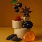 AEMBR candle scent notes with black currant, star anise, saffron, blackberry, and amber stones