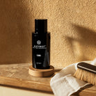 AEMBR AlkyMist multi-use fragrance bottle on wooden shelf with natural brush and cloth