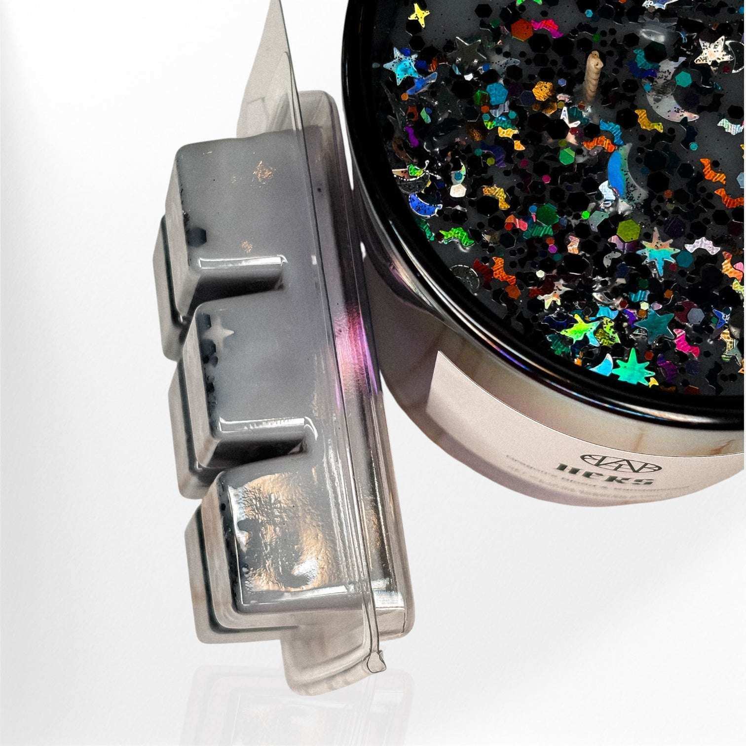 AEMBR glitter soy candle with colorful star confetti and wax melts on white background