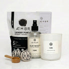 Non-toxic laundry detergent, natural wool dryer balls, multi-use fragrance spray, and scented candle bundle.