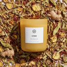 AEMBR Citron candle with saffron, ginger, and citronella on dried botanical background