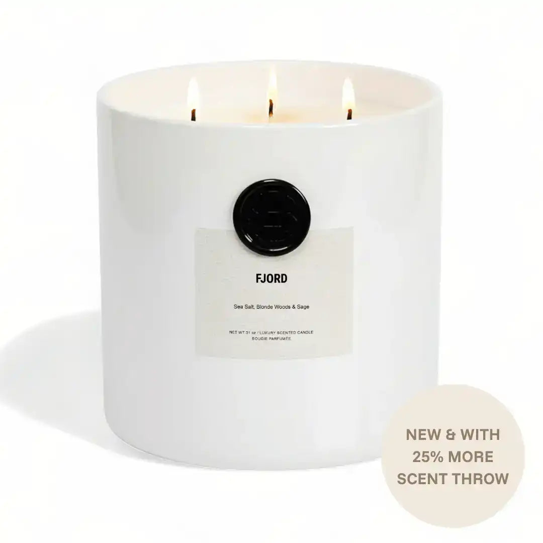 AEMBR FJORD scented candle with three wicks, sea salt, blonde woods, and sage notes.