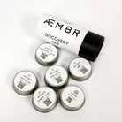 AEMBR Discovery Set sample candle tins with minimalist white and black packaging.