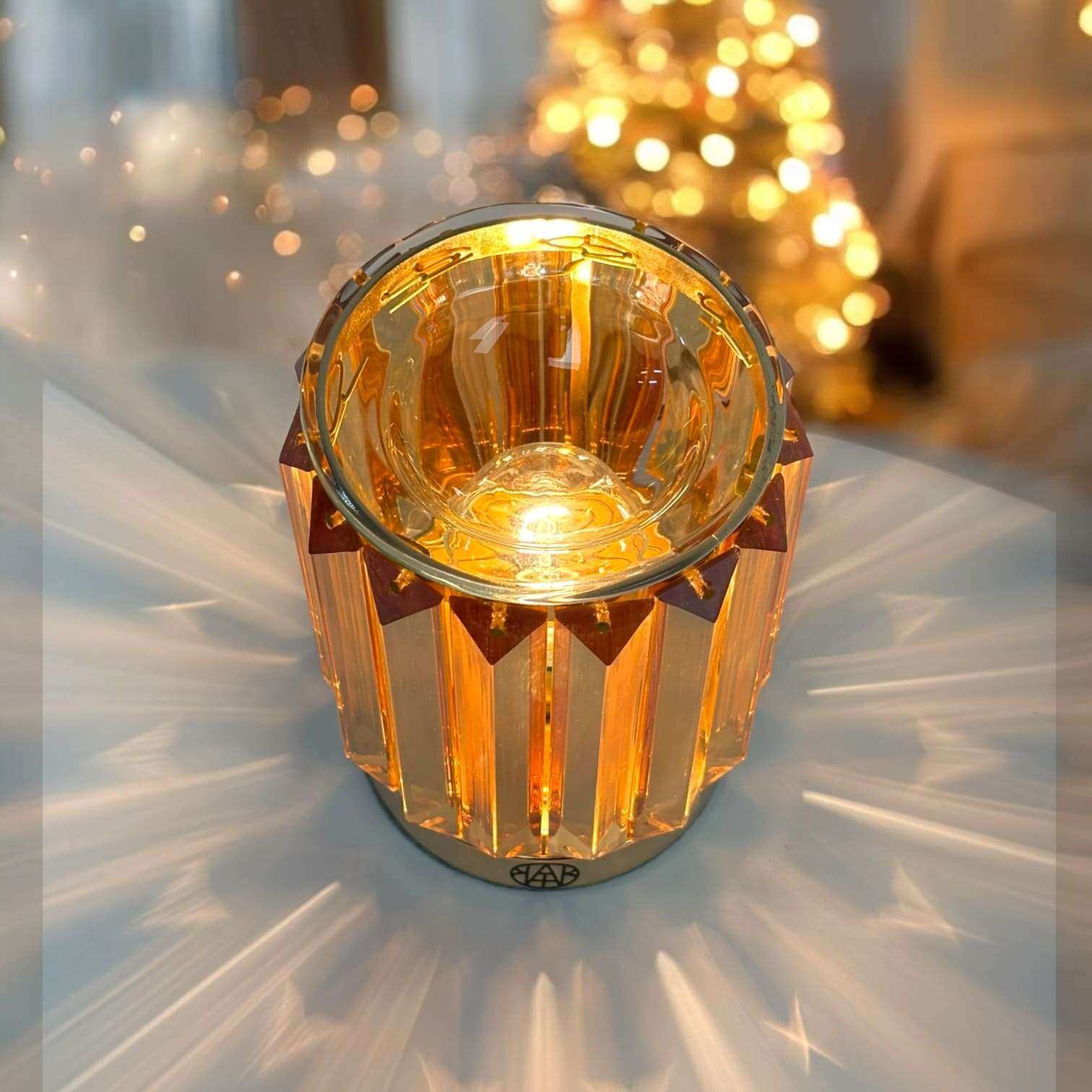 AEMBR crystal candle holder glowing warmly on table, with golden light rays and blurred festive background