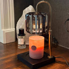 AEMBR non-toxic candle under a stylish lamp warmer on wood table, home aromatherapy scene