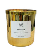 AEMBR Fraser Fir gold candle jar with label, featuring fresh fir balsam, frankincense, and myrrh.