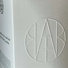 AEMBR embossed logo on a white product box, minimalist non-toxic home essentials packaging