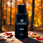 ALKYMIST multi-use fragrance bottle on a wooden surface with autumn leaves in a forest setting