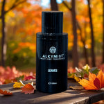 ALKYMIST multi-use fragrance bottle on a wooden surface with autumn leaves, outdoors in fall