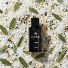 AEMBR ALKYMIST multi-use fragrance bottle on natural salts, herbs, and wood chips.