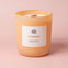 AEMBR Cloudberry scented candle in peach glass jar on soft pink background