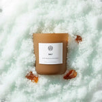 AEMBR Salt scented candle on sea salt crystals, non-toxic home fragrance product.