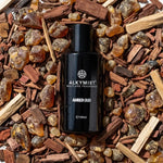 Alkymist Amber Oud multi-use fragrance bottle on wood chips and resin, non-toxic home scent