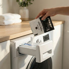 AEMBR laundry powder poured into washing machine in a bright, clean laundry room