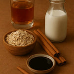 Spiced oat milk ingredients including oat flakes, cinnamon sticks, milk, syrup, and amber liquid.