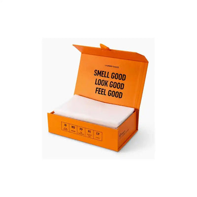 Non-toxic laundry detergent sheets in orange box with 'smell good look good feel good' text.