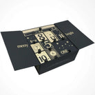AEMBR advent calendar 2025 with black and gold numbered boxes, star accents, open holiday packaging