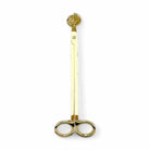 Gold wick trimmer accessory by AEMBR, featuring a sleek design for trimming candle wicks.