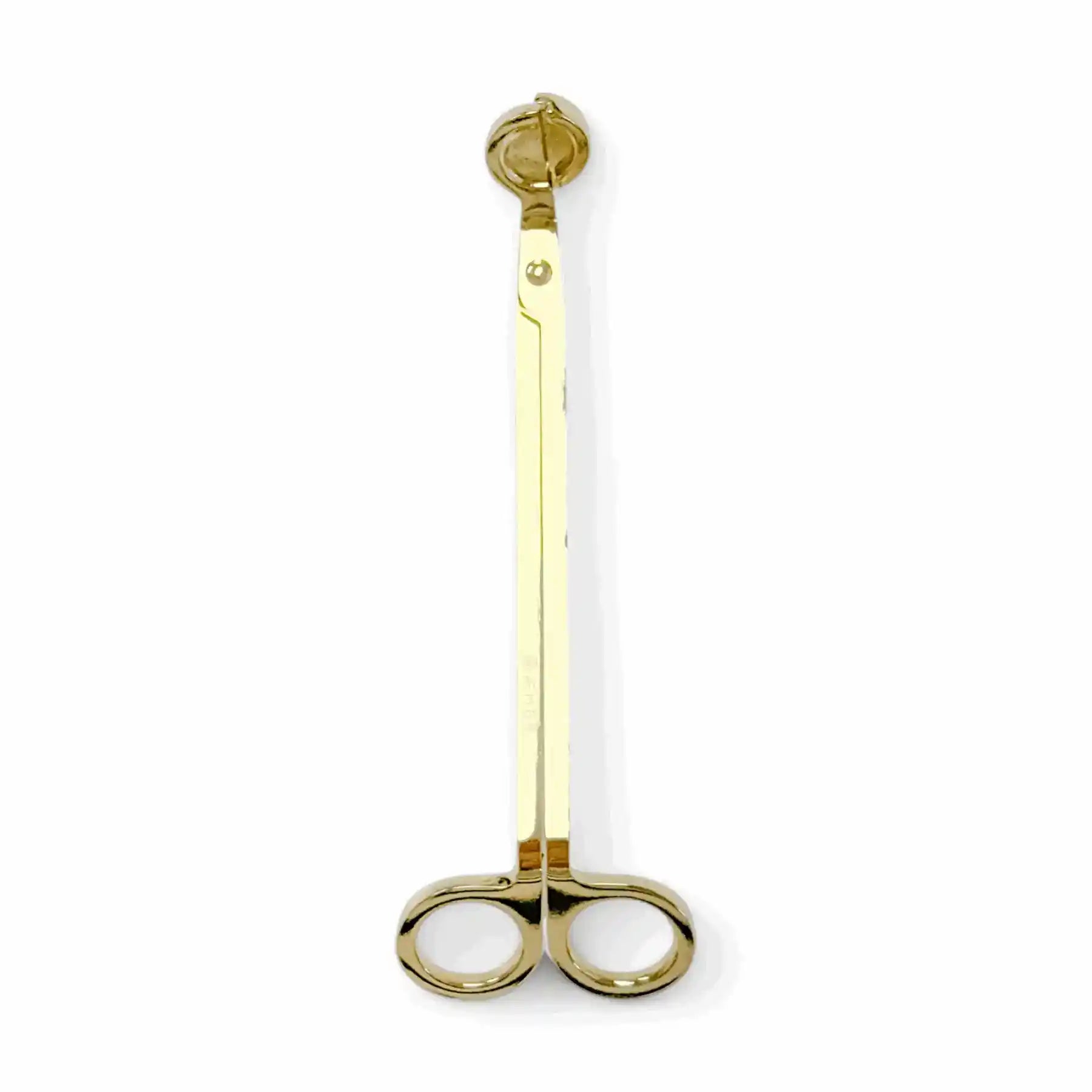 Gold wick trimmer accessory by AEMBR, featuring a sleek design for trimming candle wicks.