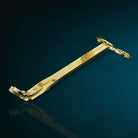 Gold wick trimmer from AEMBR accessories set, featuring a sleek design for trimming candle wicks.