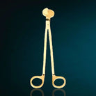 AEMBR gold wick trimmer for candles, with a sleek metallic finish and ergonomic handle, designed for trimming candle wicks.