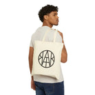 AEMBR The Book Tote bag with beige canvas and brown leather handles, featuring a spacious interior and stylish design.