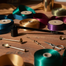 Assorted ribbons and jewelry-making supplies on a wooden surface with soft lighting.