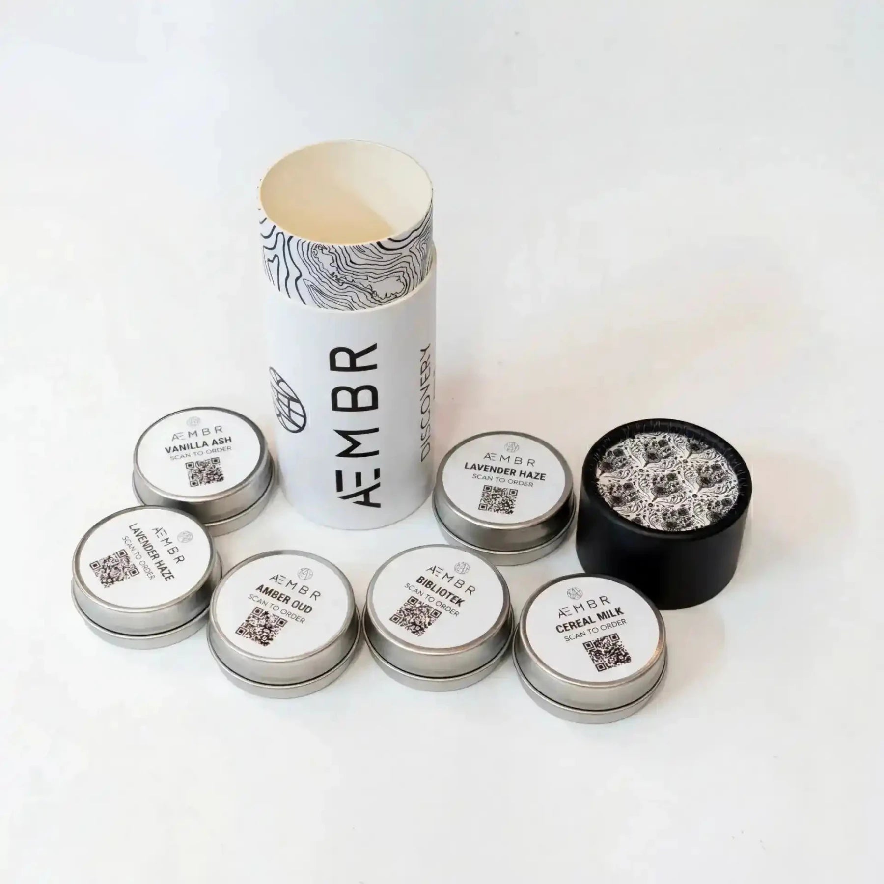 AEMBR Discovery Set of candles with various scents, arranged in a sleek box, featuring minimalist packaging and elegant design.