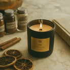 AEMBR Hygge Candle with a white ceramic holder and a lit wick, creating a cozy, warm ambiance.