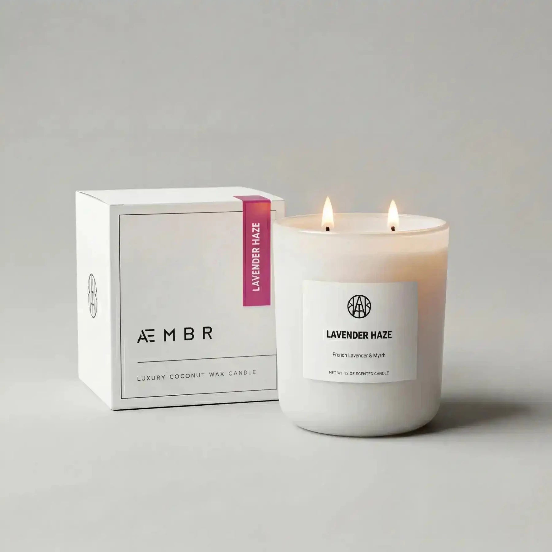 AEMBR Lavender Haze Candle with a sleek glass jar and lavender-colored wax, emitting a calming, floral scent.