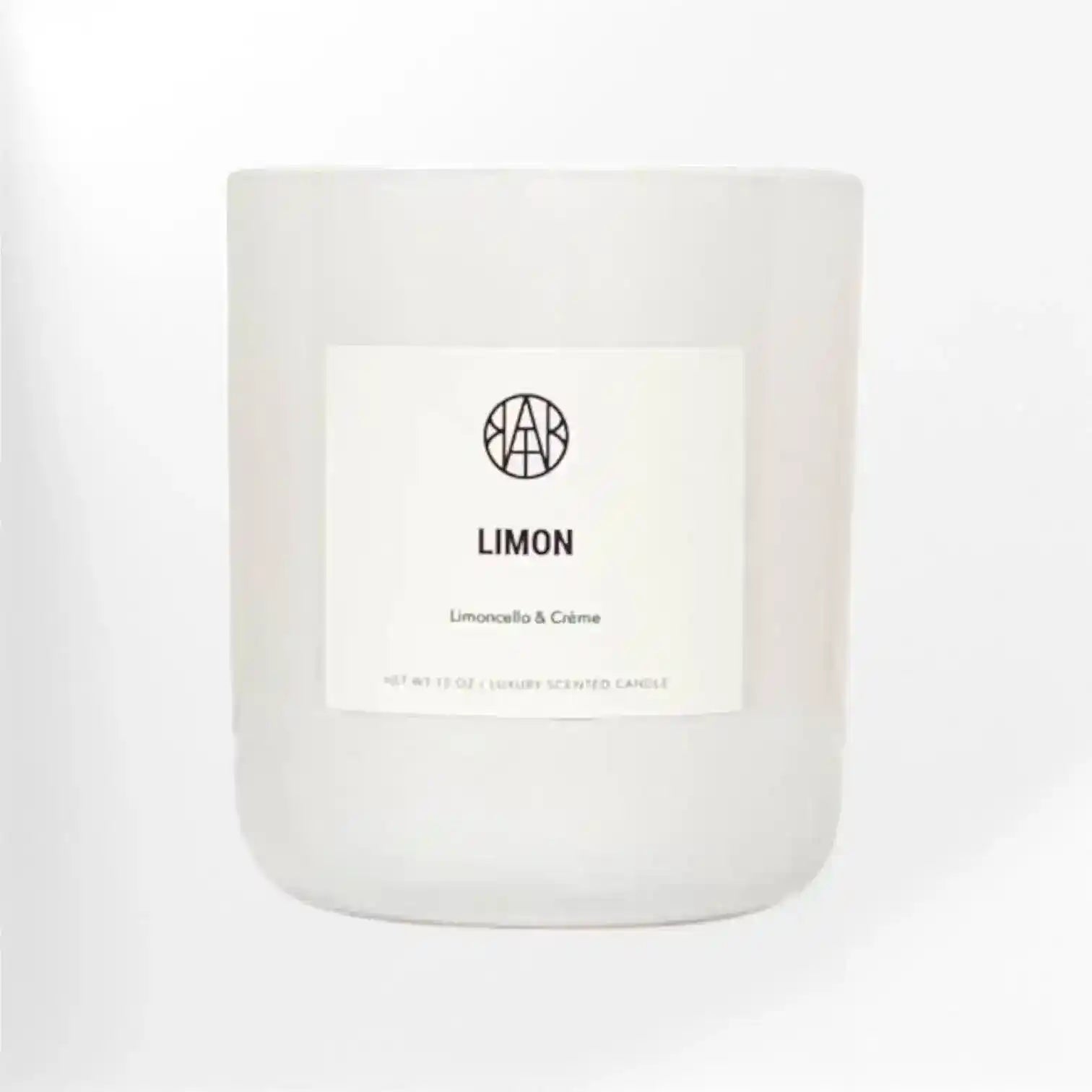 AEMBR Limon Candle with a sleek glass holder, yellow citrus scent, and soft flickering flame, perfect for cozy home decor.