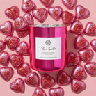 AEMBR Love Spell Candle with a decorative glass holder, featuring a pink and purple label design for romantic ambiance.