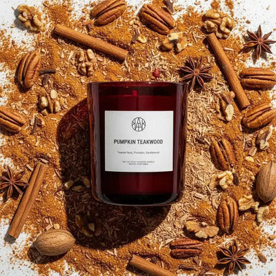 AEMBR Pumpkin Teakwood Candle with a warm, decorative candle holder featuring a pumpkin and teakwood scent.