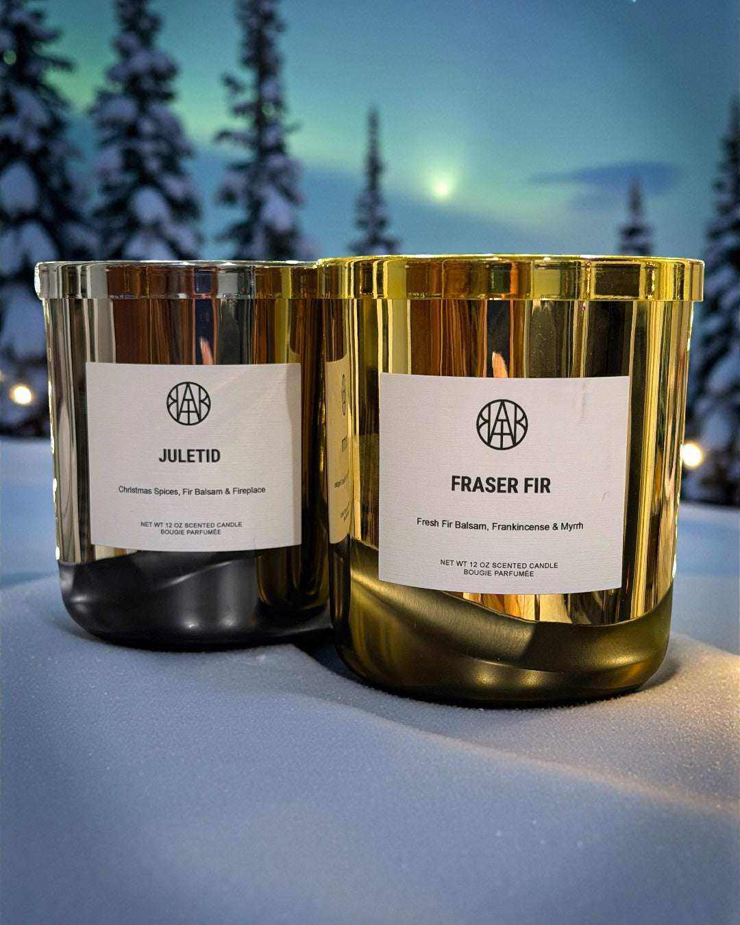 Non-toxic scented candles set with gold jars, Juletid and Fraser Fir, on snowy background
