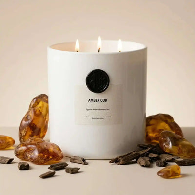 AEMBR The Viking Amber Oud candle with a sleek black container and warm amber-colored wax.