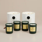 Winter non-toxic candles in white and green jars with gold labels, natural home fragrance