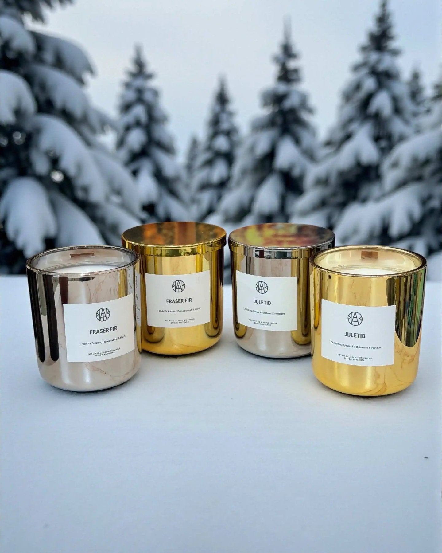 AEMBR Fraser Fir candles in Silver & Gold Editions with festive green pine and silver and gold accents, perfect for holiday decor.