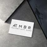 AEMBR instant gift card on textured gray stone, minimal modern design