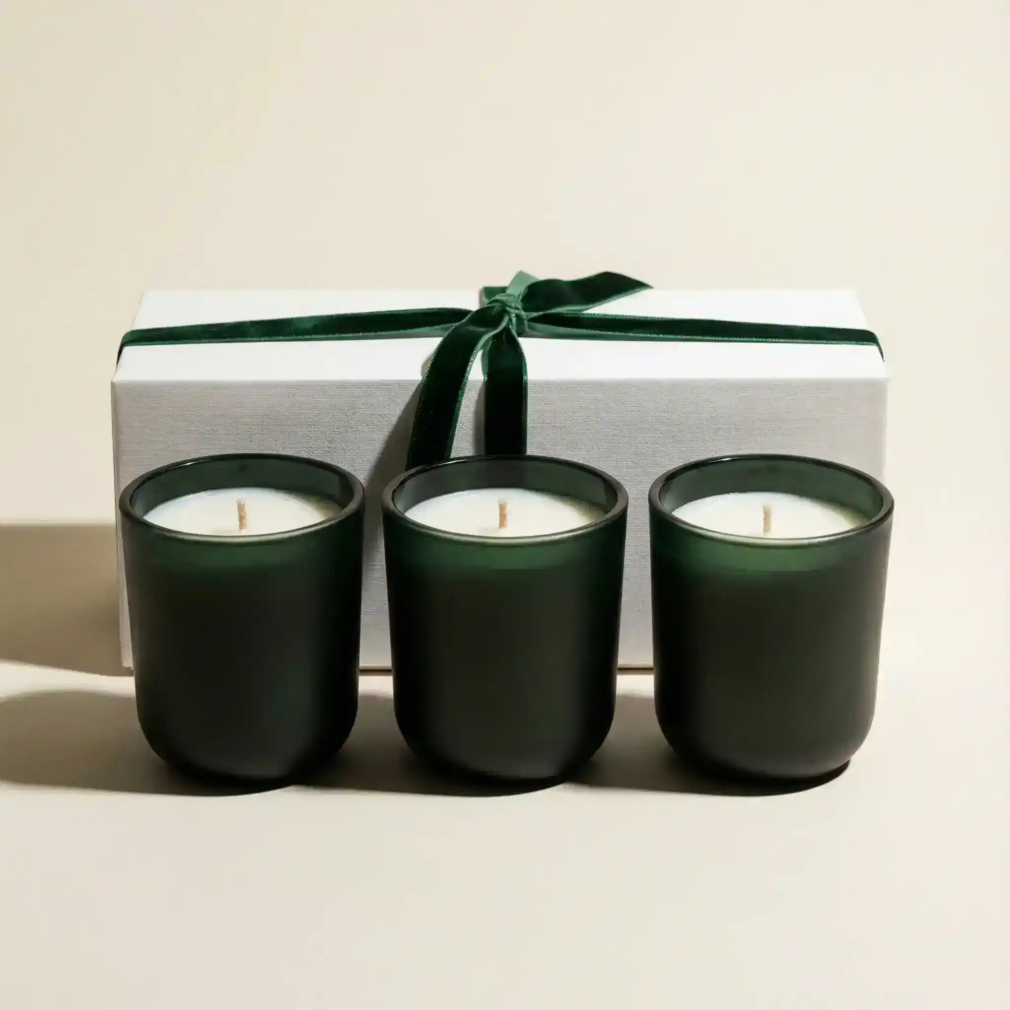 AEMBR Winter Votive Trio Gift Set with three decorative winter-themed candles in glass holders, perfect for holiday decor.