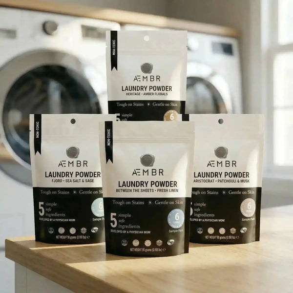 AEMBR laundry detergent scent sampler pack with small bottles of various fragrances for laundry powder testing.