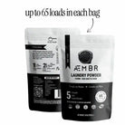 AEMBR luxury laundry gift set with sea salt, sage, blonde woods scents, including detergent and fabric softener bottles.
