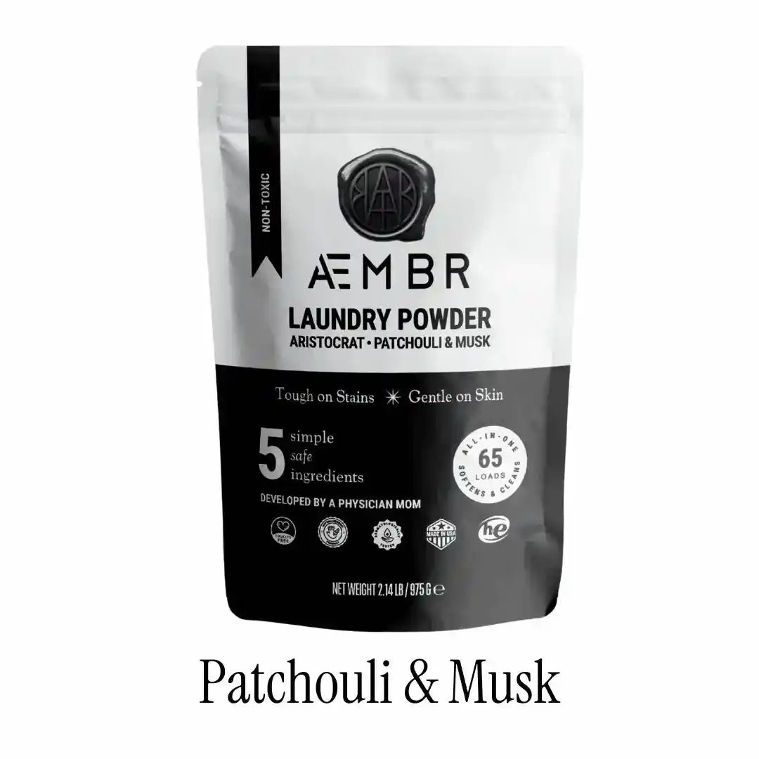 AEMBR luxury laundry gift set with Fjord Sea Salt, Sage Blonde Woods scents, including detergent bottles and fabric softener.