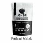 AEMBR luxury laundry gift set with Fjord Sea Salt, Sage Blonde Woods scents, including detergent bottles and fabric softener.