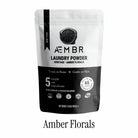 Non-toxic laundry detergent powder amber florals scent in resealable black and white bag, 65 loads