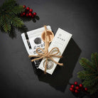 Non-toxic laundry detergent gift set with wooden scoop, holiday greenery and berries