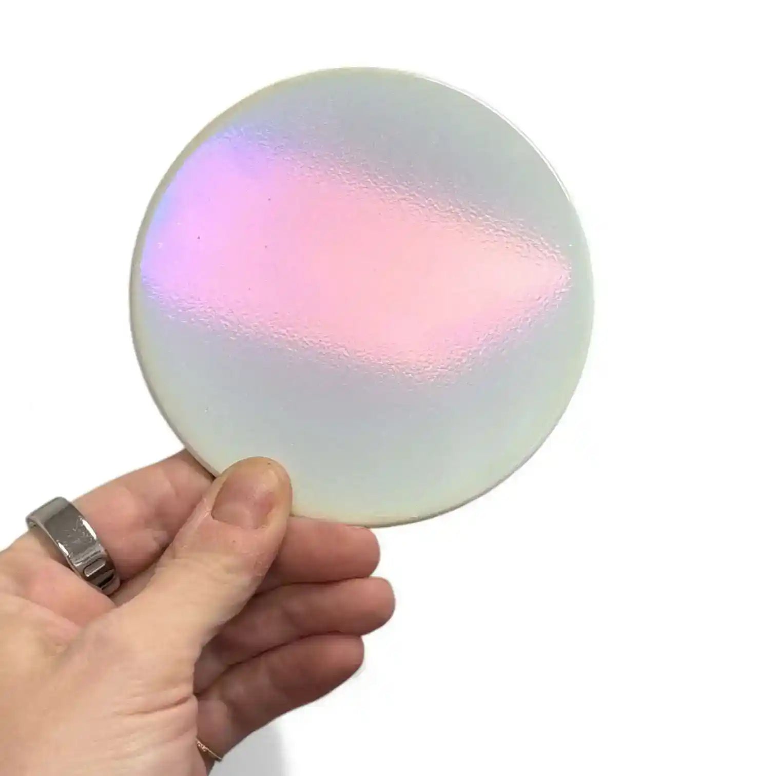 Iridescent white deluxe candle lid by AEMBR, showing its smooth, reflective surface and lid design for candles.